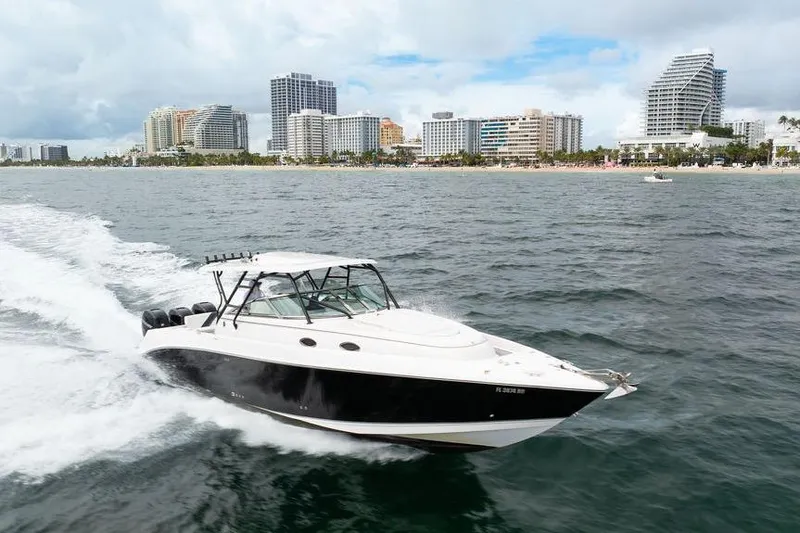  Yacht Photos Pics 2008 Donzi 38 ZSF boat cruising near city skyline on the water.