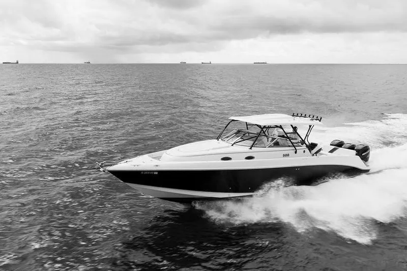  Yacht Photos Pics 2008 Donzi 38 ZSF speedboat cruising on open water under cloudy skies.