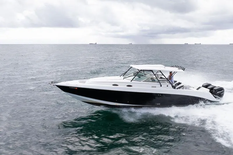  Yacht Photos Pics 2008 Donzi 38 ZSF speedboat cruising on open water under cloudy skies.