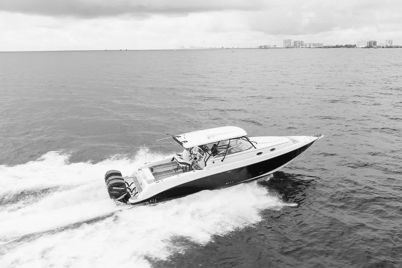  Yacht Photos Pics 2008 Donzi 38 ZSF boat cruising on open water, city skyline in background.