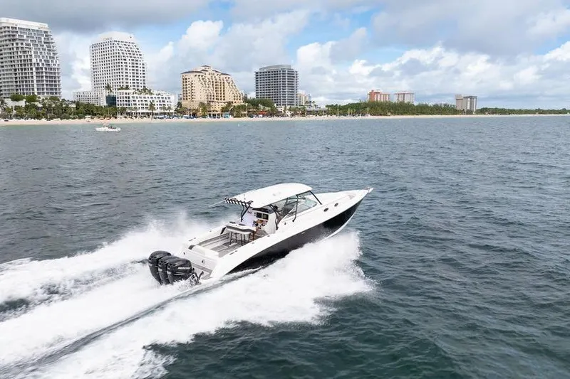  Yacht Photos Pics 2008 Donzi 38 ZSF boat cruising near a city shoreline with modern buildings.