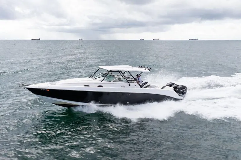  Yacht Photos Pics 2008 Donzi 38 ZSF speedboat cruising on open water under cloudy skies.