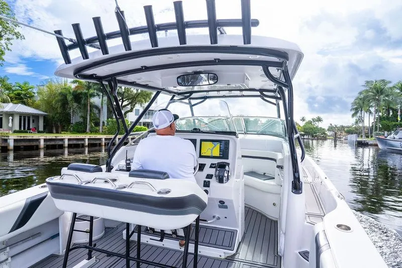  Yacht Photos Pics 2008 Donzi 38 ZSF boat interior with captain navigating through a scenic waterway.