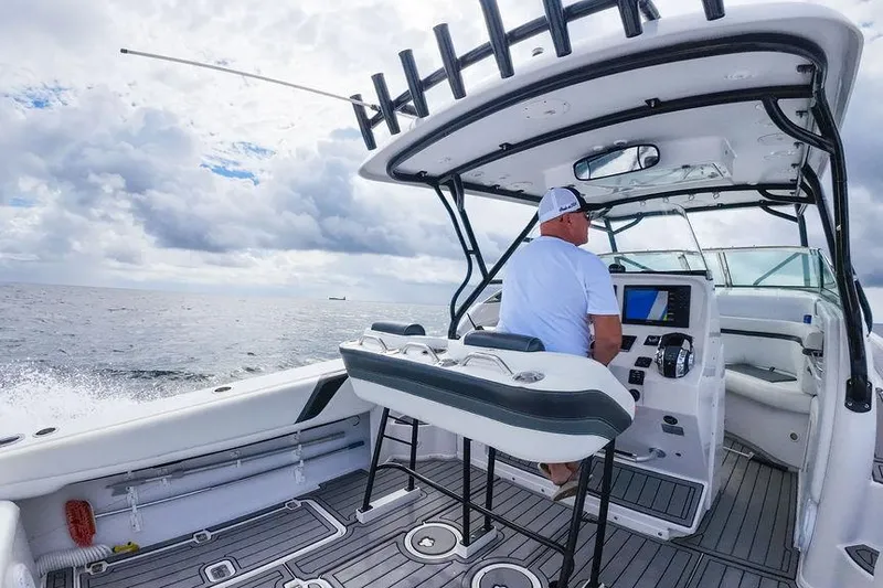  Yacht Photos Pics 2008 Donzi 38 ZSF boat on open water, man steering under cloudy sky.