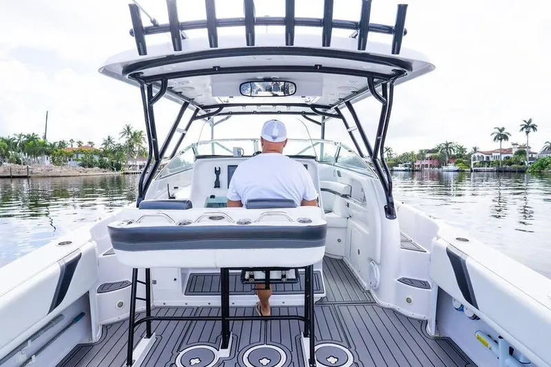  Yacht Photos Pics 2008 Donzi 38 ZSF boat interior with captain navigating calm waters.