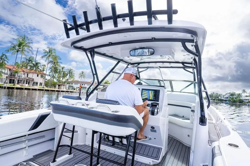  Yacht Photos Pics 2008 Donzi 38 ZSF boat with captain navigating, surrounded by palm trees and waterfront homes.