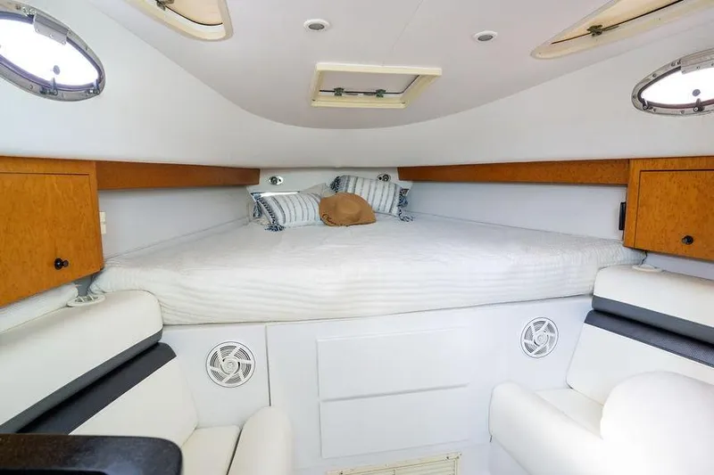  Yacht Photos Pics 2008 Donzi 38 ZSF cabin interior with bed, cushions, and wooden storage cabinets.