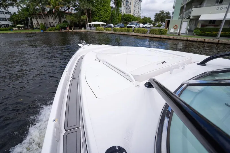  Yacht Photos Pics 2008 Donzi 38 ZSF boat cruising on a calm waterway near residential area.