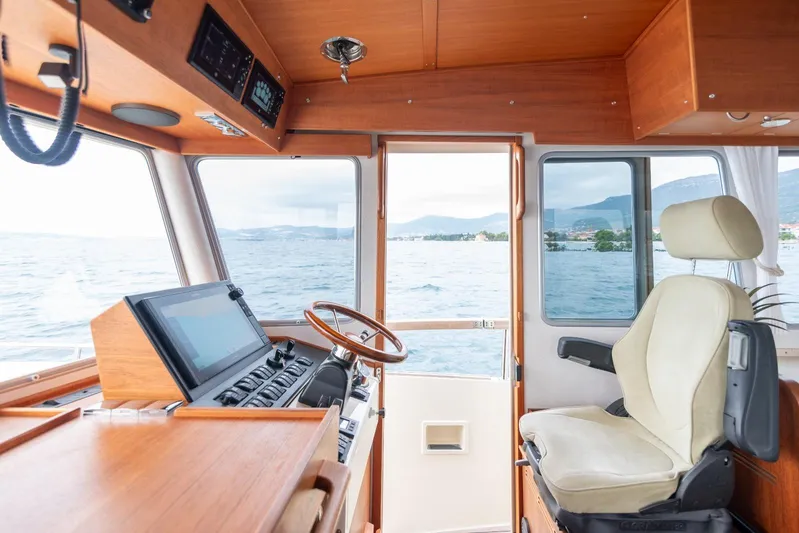 Gala Yacht Photos Pics Interior of 2019 Targa 46 boat with steering wheel and navigation controls.