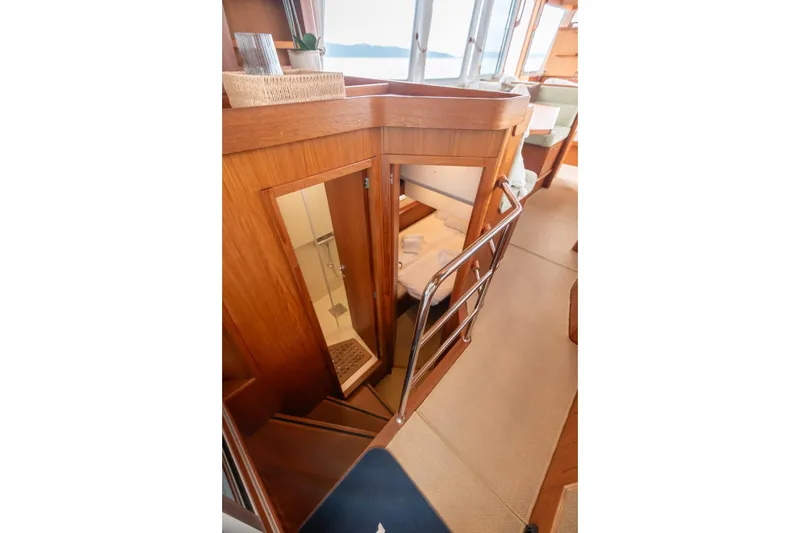 Gala Yacht Photos Pics Interior of 2019 Targa 46 yacht, featuring wooden stairs and cozy cabin entrance.