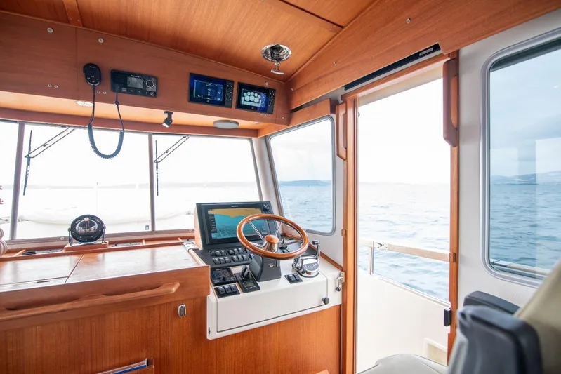 Gala Yacht Photos Pics Interior of 2019 Targa 46 boat cockpit with navigation equipment and wooden finish.