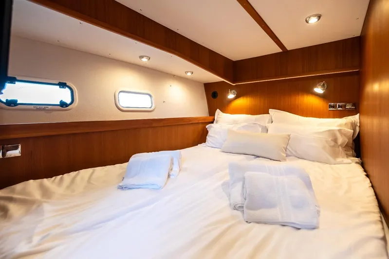 Gala Yacht Photos Pics Cozy cabin bedroom in 2019 Targa 46 yacht with wooden interior and soft lighting.