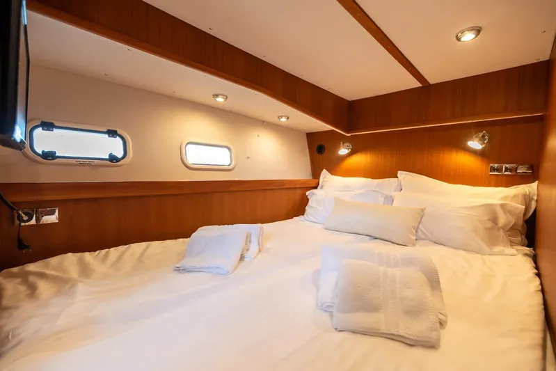 Gala Yacht Photos Pics Cozy cabin interior of 2019 Targa 46 yacht with comfortable bedding and ambient lighting.