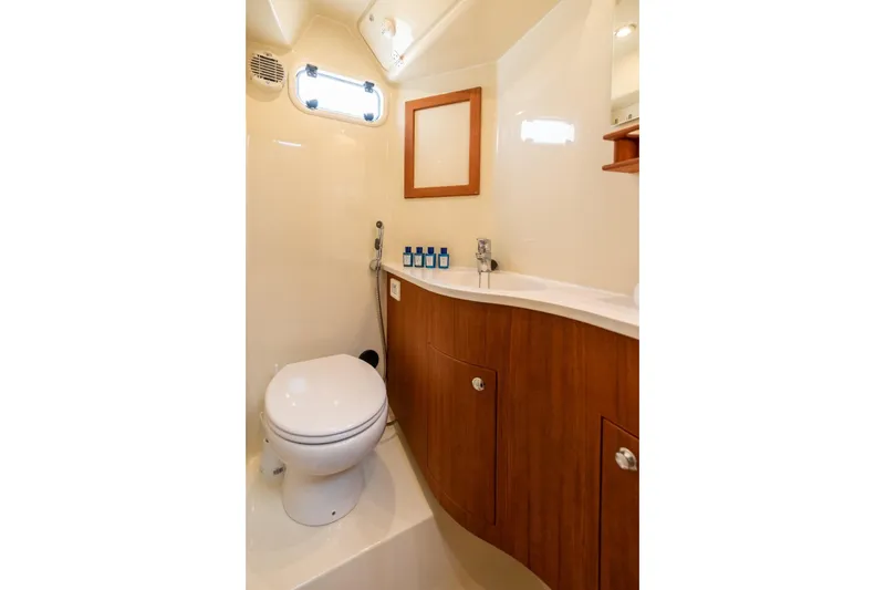 Gala Yacht Photos Pics Compact bathroom in 2019 Targa 46 yacht with wooden cabinetry and modern fixtures.