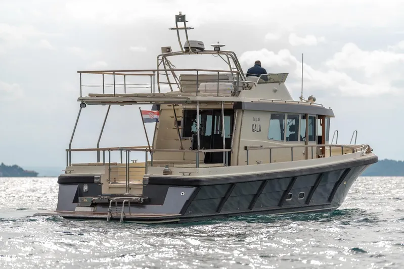 Gala Yacht Photos Pics 2019 Targa 46 yacht cruising on open water, rear view.