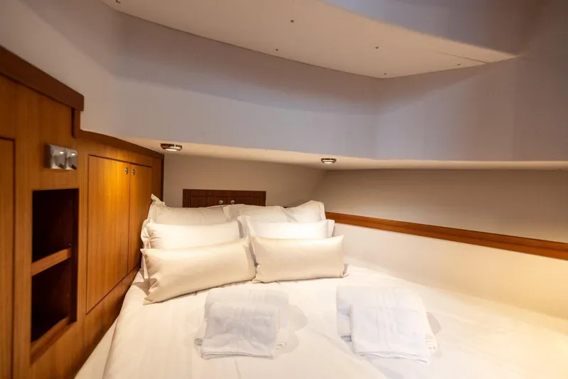 Gala Yacht Photos Pics Cozy cabin interior of 2019 Targa 46 yacht with plush bedding and wooden accents.