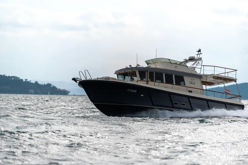 Gala Yacht Photos Pics 2019 Targa 46 yacht cruising on open water, side view.