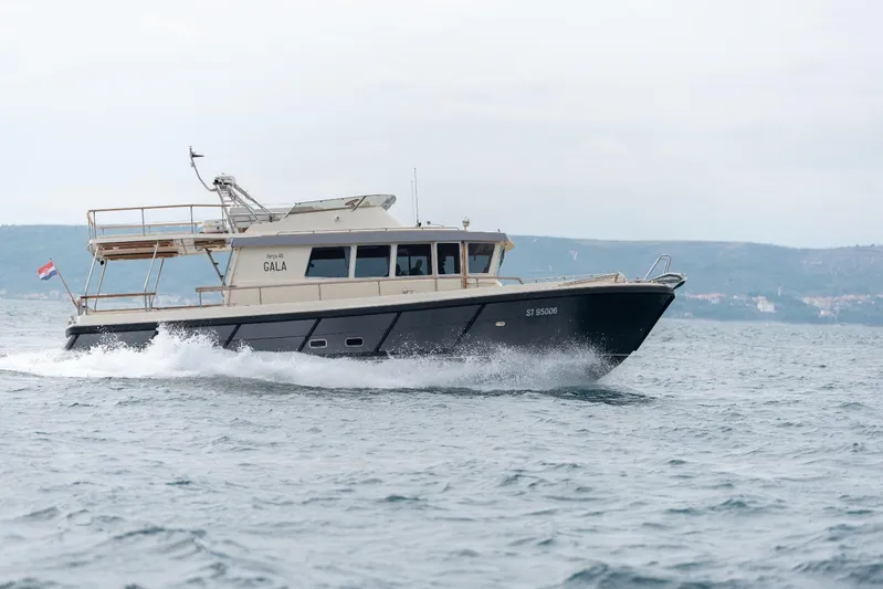 Gala Yacht Photos Pics 2019 Targa 46 boat cruising on open water with scenic background.