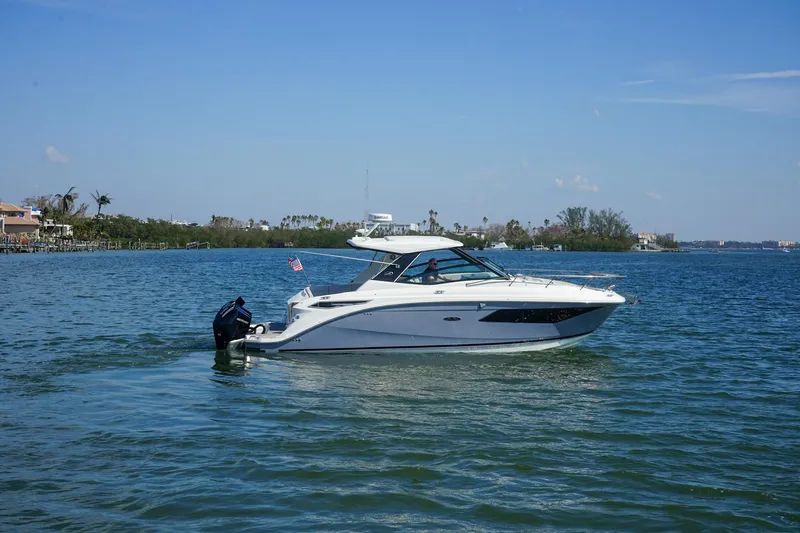 Capstone I Yacht Photos Pics 2023 Sea Ray Sundancer 320 Outboard cruising on a sunny day in calm waters.