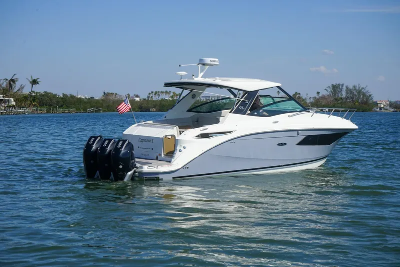Capstone I Yacht Photos Pics 2023 Sea Ray Sundancer 320 Outboard cruising on a sunny day with triple engines.