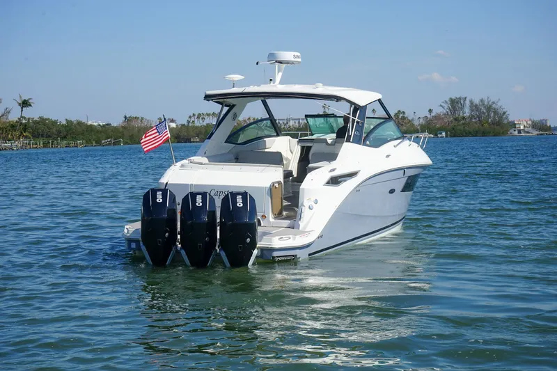 Capstone I Yacht Photos Pics 2023 Sea Ray Sundancer 320 Outboard cruising on a sunny day with American flag.