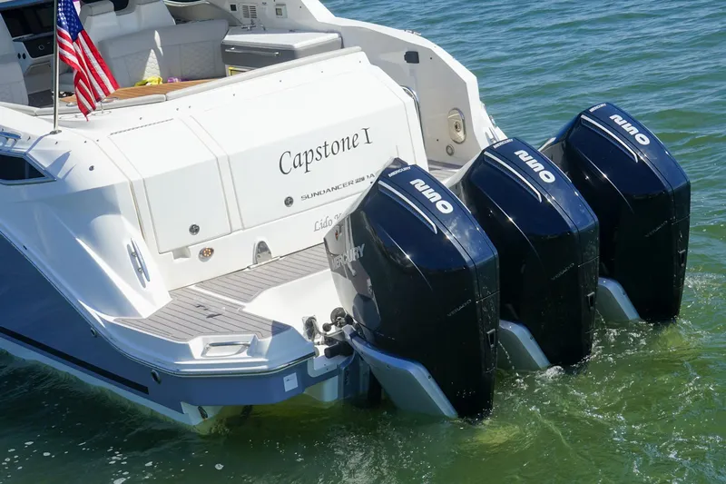 Capstone I Yacht Photos Pics 2023 Sea Ray Sundancer 320 Outboard with triple engines, American flag, on water.