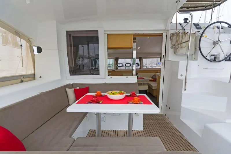 K3 Yacht Photos Pics Interior of 2019 Lagoon 50 catamaran with dining area and helm station.