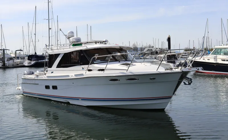 The Islander Yacht Photos Pics 2018 Cutwater C-302 Coupe boat docked in marina, surrounded by other vessels.