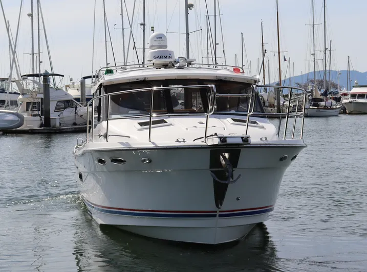 The Islander Yacht Photos Pics 2018 Cutwater C-302 Coupe boat docked in a marina, surrounded by other vessels.