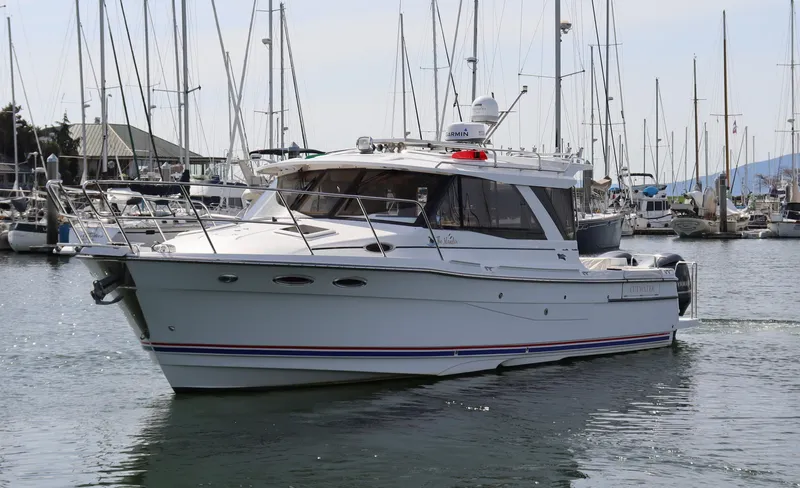 The Islander Yacht Photos Pics 2018 Cutwater C-302 Coupe boat docked in a marina with sailboats.