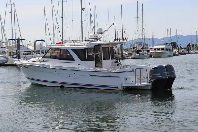 The Islander Yacht Photos Pics 2018 Cutwater C-302 Coupe boat docked in a marina with other vessels.