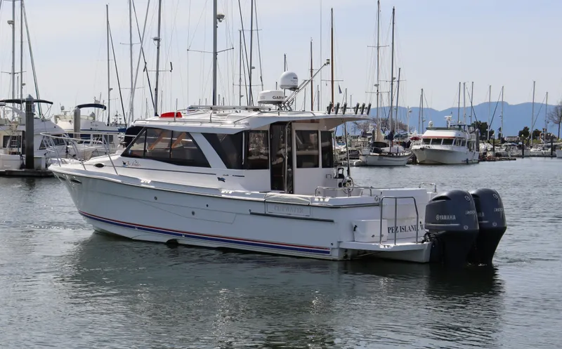 The Islander Yacht Photos Pics 2018 Cutwater C-302 Coupe boat docked in a marina with twin outboard engines.