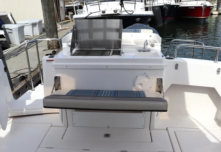 The Islander Yacht Photos Pics 2018 Cutwater C-302 Coupe boat with outdoor grill and seating area.