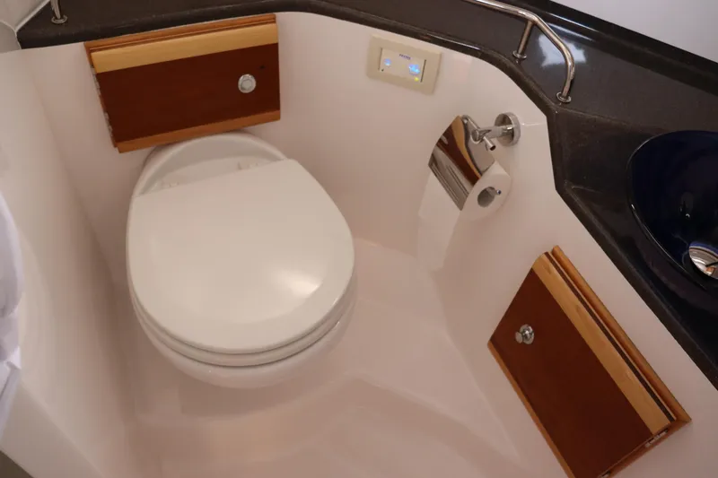 The Islander Yacht Photos Pics 2018 Cutwater C-302 Coupe bathroom with modern fixtures and wooden accents.