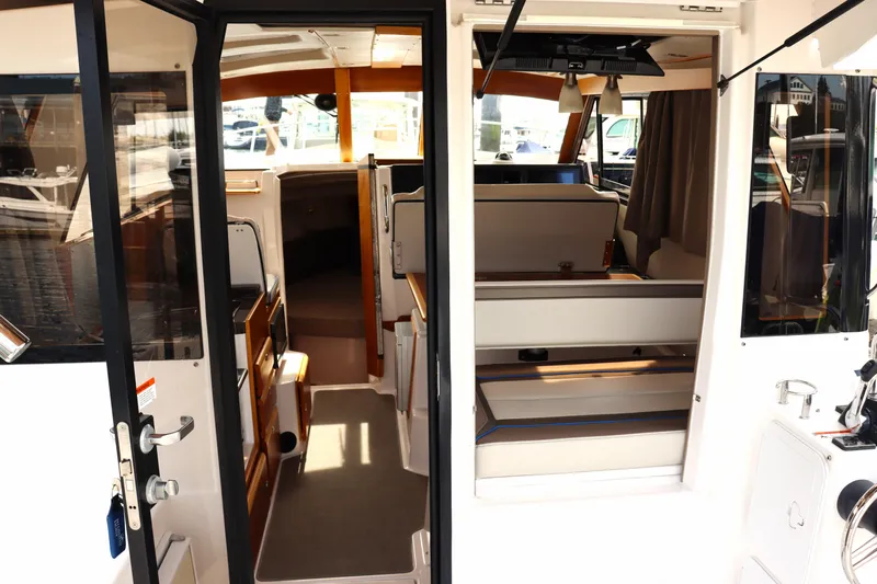 The Islander Yacht Photos Pics Interior view of 2018 Cutwater C-302 Coupe boat, showcasing seating and cabin area.