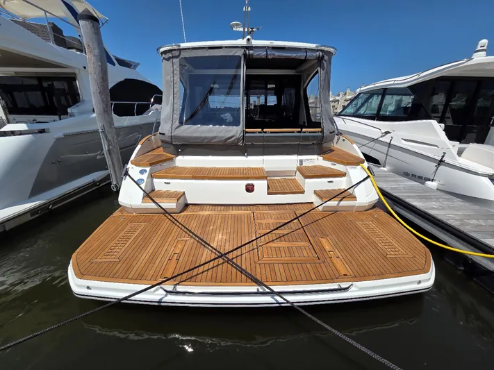  Yacht Photos Pics 2026 Marex 440 yacht with teak deck, docked at marina under clear blue sky.