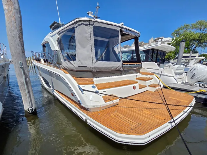  Yacht Photos Pics 2026 Marex 440 yacht docked, featuring sleek design and spacious wooden deck.