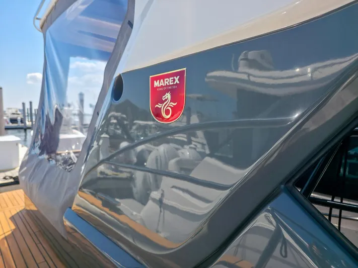  Yacht Photos Pics 2026 Marex 440 yacht with sleek design and logo, docked under clear blue sky.