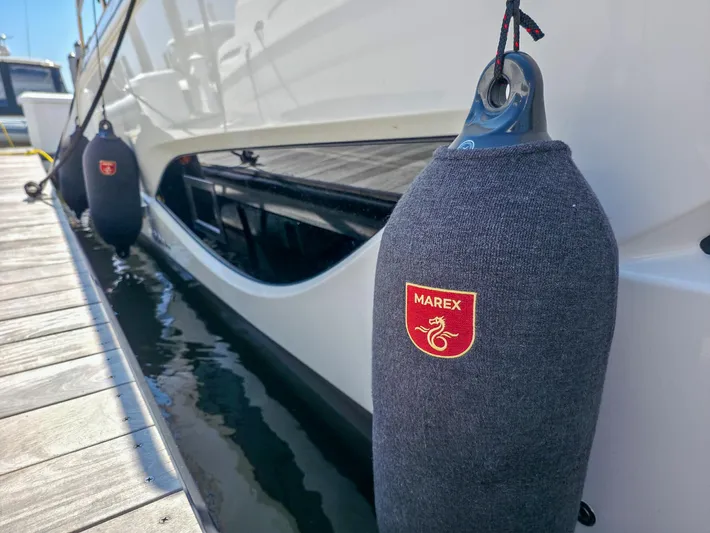  Yacht Photos Pics 2026 Marex 440 yacht docked with protective fenders, showcasing brand logo.