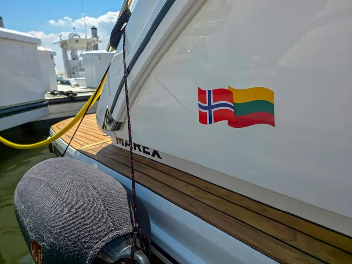  Yacht Photos Pics Marex 440 yacht, 2026 model, docked with Norwegian and Lithuanian flags displayed.