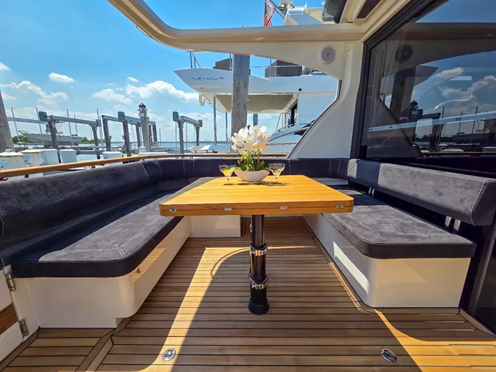  Yacht Photos Pics Luxurious Marex 440 yacht deck with elegant seating and wooden table, 2026 model.