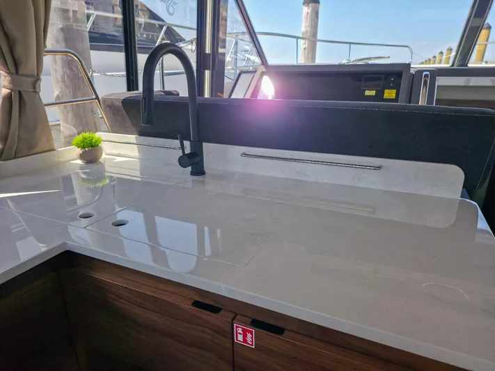  Yacht Photos Pics Modern kitchen area on 2026 Marex 440 yacht with sleek countertop and faucet.