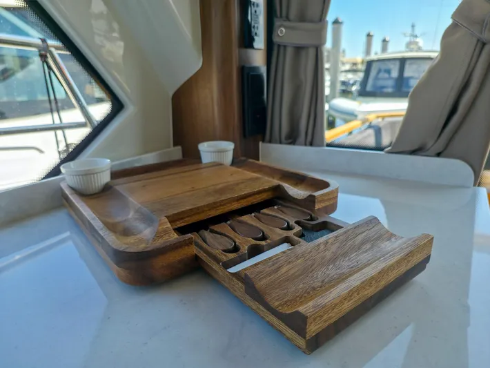  Yacht Photos Pics Interior of 2026 Marex 440 yacht with wooden tray and storage compartments.