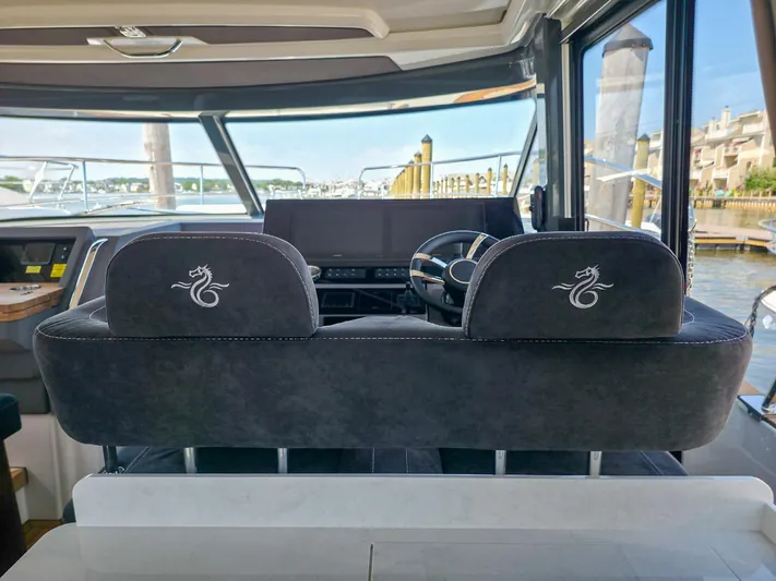  Yacht Photos Pics Interior view of 2026 Marex 440 yacht cockpit with dual seats and steering wheel.