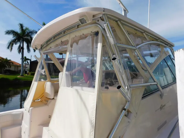  Yacht Photos Pics 2008 Grady-White Express 360 boat with enclosed cockpit, docked near palm trees.