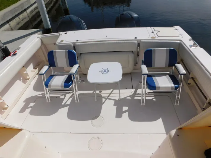  Yacht Photos Pics 2008 Grady-White Express 360 boat deck with chairs and table.