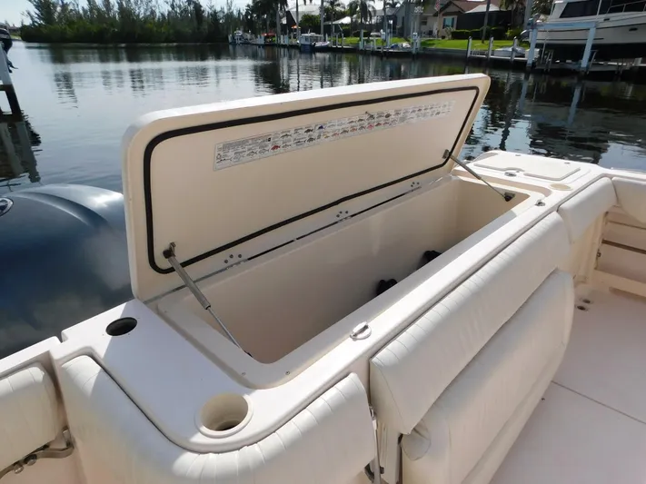  Yacht Photos Pics 2008 Grady-White Express 360 boat with open storage compartment by the water.