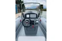 2022 Marshall M4 Touring boat dashboard with Garmin navigation system on a calm river.