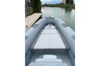 2022 Marshall M4 Touring boat on a calm river, featuring spacious seating.