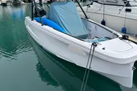 2022 Axopar 22 T-Top boat docked in a marina, surrounded by other vessels.